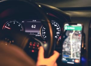 closeup-steering-wheel-navigator-car-night-scaled.jpg