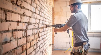 handyman-construction-site-process-drilling-wall-with-perforator-scaled.jpg