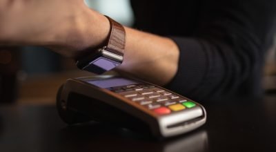 mid-section-man-making-paying-through-smartwatch-scaled.jpg